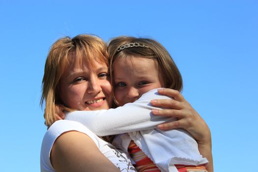 image of mother and daughter are hugging one another