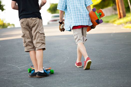 Close up of some long boarders on an urban road.