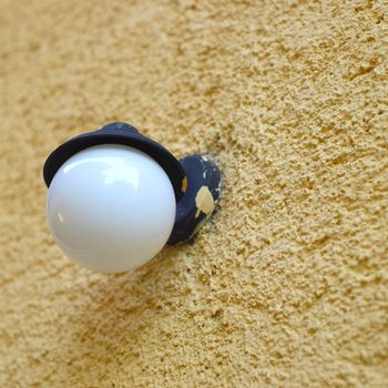 Outdoor light on an orange stucco wall