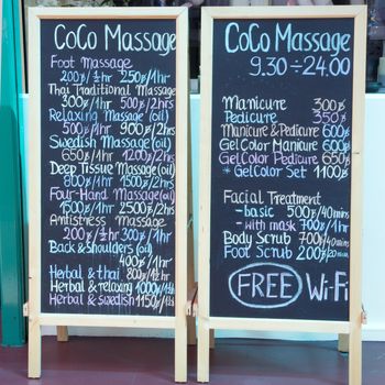 Boards offering massage and beauty treatments in Bangkok, Thailand