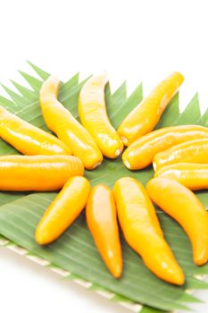 Capsicum on plate Yellow sweet peppers on a white background.