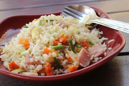 fried rice with ham on red plate