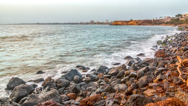 The beautiful waters of the Atlantic ocean with its rocky coastline near the City of Dakar in Senegal