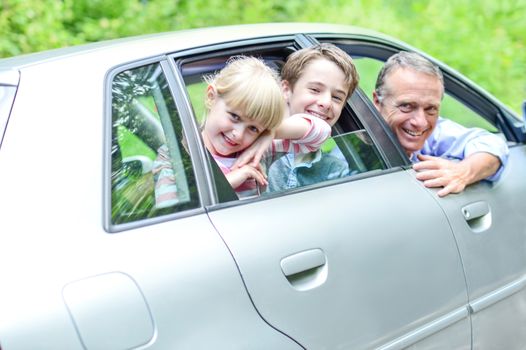 Father enjoying car drive with his kids