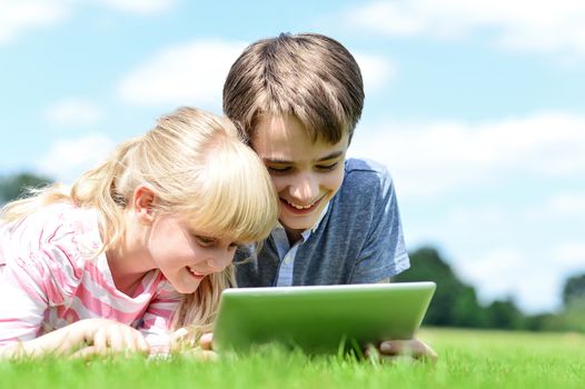 Brother and sister operating new tablet device