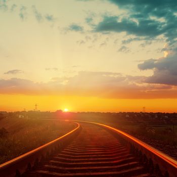 good orange sunset over railroad to horizon