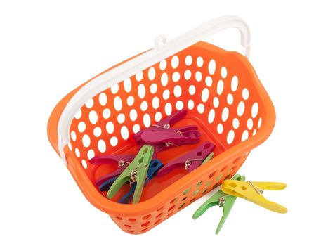 Colorful clothes pegs and orange plastic basket