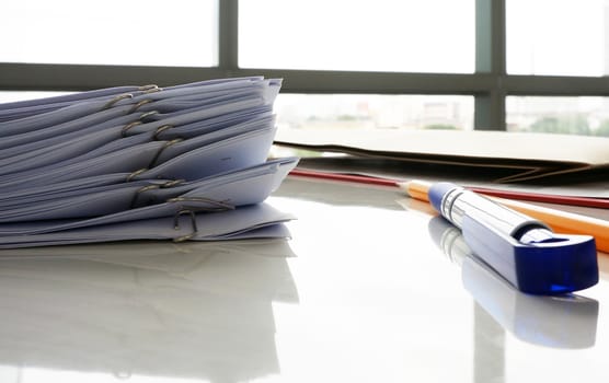 Documents prepared for the boss. Case for paper, board with pen and pencil placed on a desk.                            