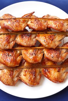 Grilled chicken wings on White background.