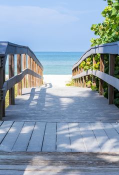 Wooden boardwalk to ocean amond sea oats on Sunset Beach at southern tip of Treasure Island Florida on Gulf of Mexico