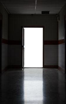 Dark corridor with isolated white background at the door
