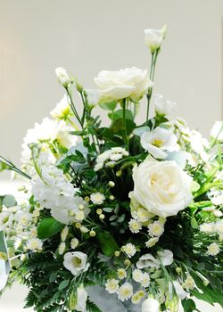 White flowers decorate a table at a wedding reception