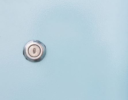 Key hole on blue steel background