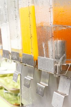 Orange juice and drinking water in dispenser