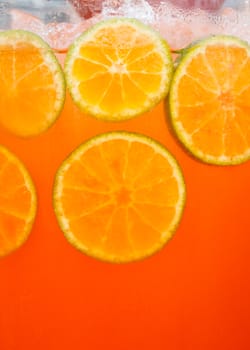 Closeup Sliced orange in glass of orange juice with ice