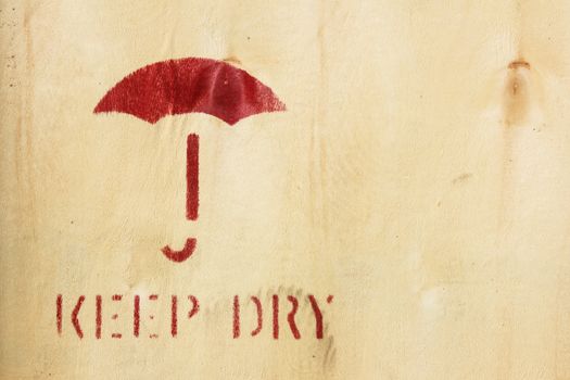 Umbrella symbol on wooden box - Keep Dry Sign