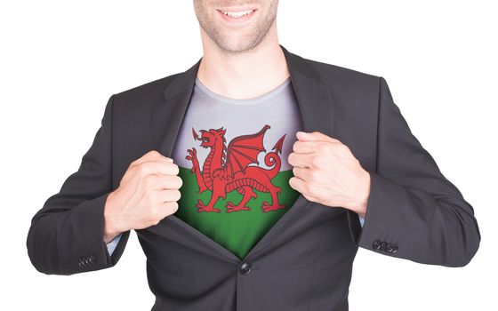 Businessman opening suit to reveal shirt with flag, Wales