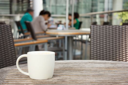 cup of coffee on table at coffee shop