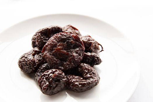 pitted prunes on a white background