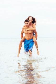 Summer, sea. Attractive couple on the beach