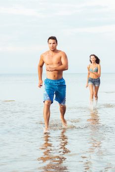 Summer, sea. Attractive couple on the beach