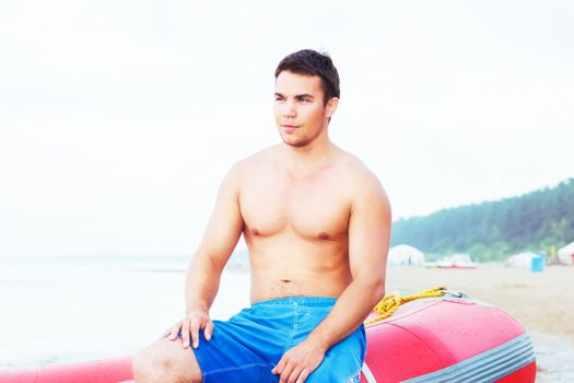 Lifeguard, summer. Handsome man on the beach