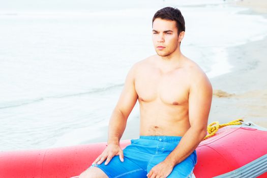 Lifeguard, summer. Handsome man on the beach