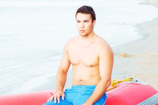 Lifeguard, summer. Handsome man on the beach