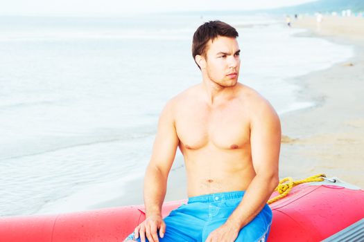 Lifeguard, summer. Handsome man on the beach