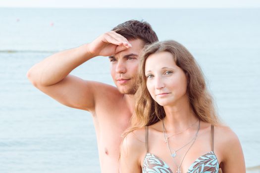 Summer, sea. Attractive couple on the beach