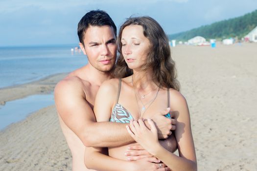 Summer, sea. Attractive couple on the beach