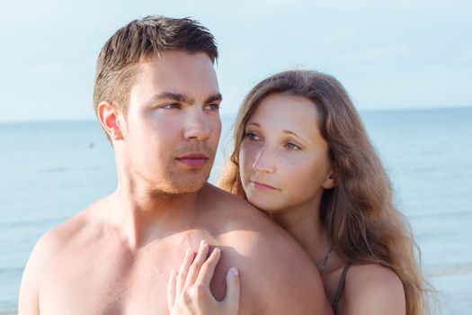 Summer, sea. Attractive couple on the beach