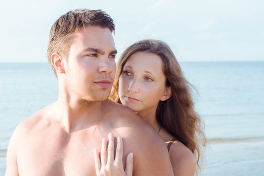 Summer, sea. Attractive couple on the beach