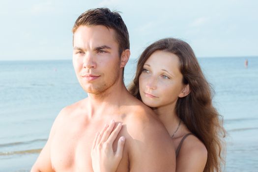 Summer, sea. Attractive couple on the beach