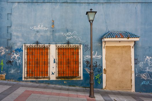 Curiosus image of a bricked up house with lamppost and graffitis in the street Salamance Spain