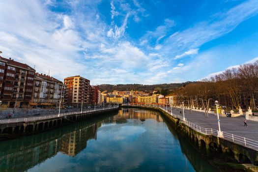 Pan view of Nervion river in the city center of Bilbao with promenade on the right Basque Country Spain