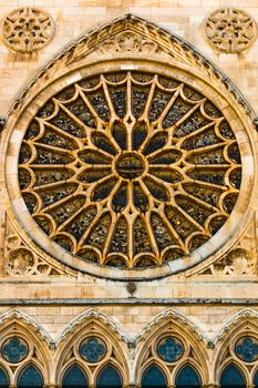 View of the entrance rose window, stained glasses and lancet arch shapes in the gothic cathedral of Leon, Spain