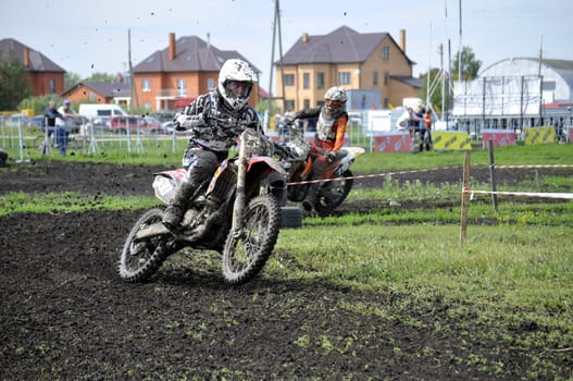 Motorcyclists on motorcycles participate in cross-country race