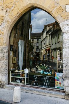 Street refelected from a window display taken inthe city of Perigueux Frech region of perigord