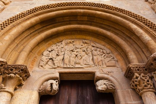 Carved tympanum  detail view of the romanesque style door  called Puerta del Cordero in the Royal San Isidoro collegiate church from the X century i n Leon Spain