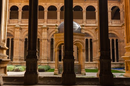 View of San Esteban dominican convent cloister with renaissance columns in the forefront in Salamanca Spain