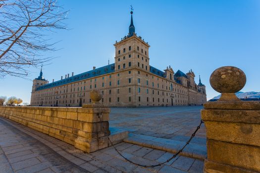 Full view of San Lorenzo de El Escorial Royal Site  showing the surounding big square and   its enormous architectural structure , Madrid Spain