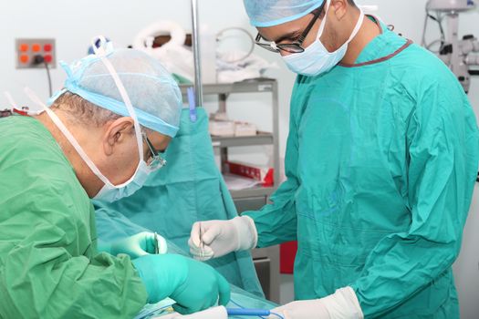 Student assistant helping doctor in a surgery