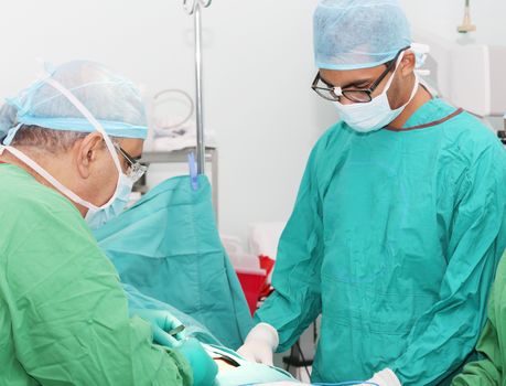 Surgeons working in operation room