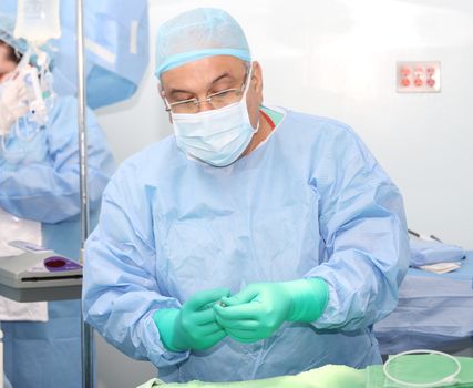 Surgeon preparing the tools for surgery