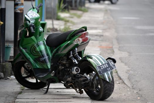 Bandung, Indonesia - July 29, 2014: Yamaha Mio Soul GT motorcycle with modification style get parked beside road.