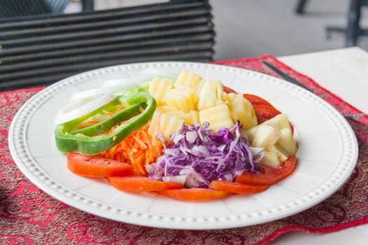 Fresh salad with tomatoes and cucumbers. on a table.