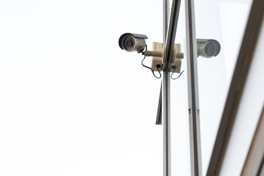 Silver CCTV camera on white background