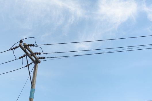 transformers of an electrical post with power-lines against brig