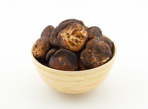 shiitake mushroom in bamboo bowl isolated on white background